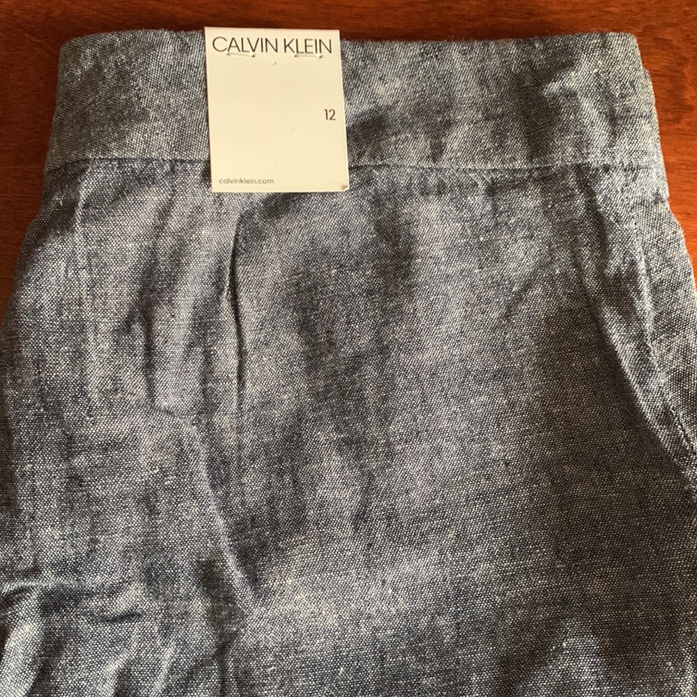 New Calvin Klein, lighter denim size 12, tags attached,pockets in front,…